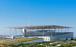 Modern building with a flat roof and vegetated areas on a green roof